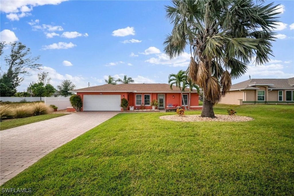 ranch-style home with a garage and a front lawn