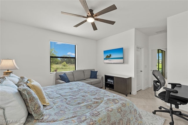 tiled bedroom featuring multiple windows and ceiling fan