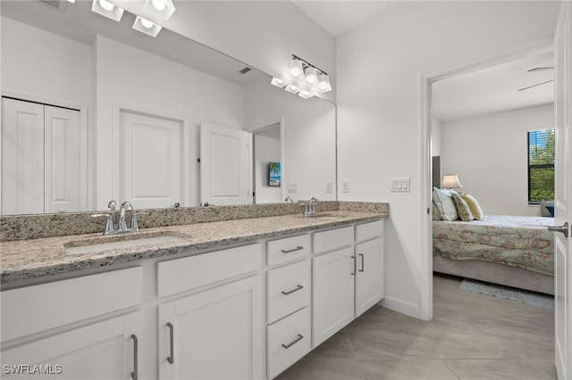 bathroom with tile patterned floors and vanity