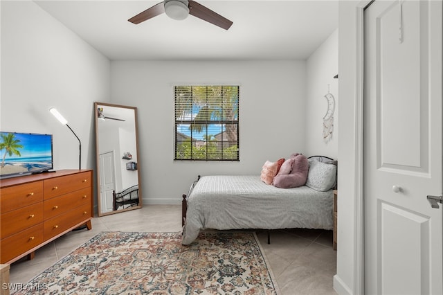 tiled bedroom featuring ceiling fan