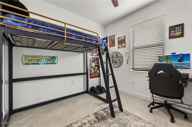 bedroom with light tile patterned floors and multiple windows