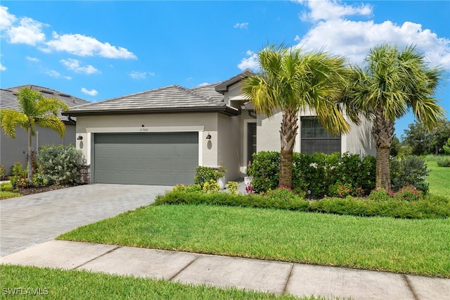 view of front of property featuring a garage and a front yard