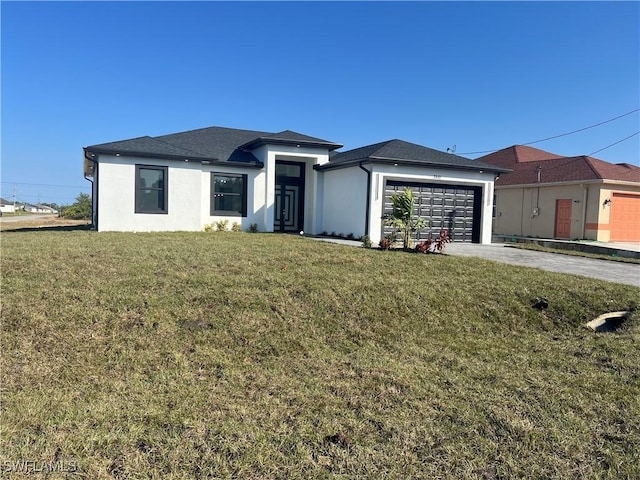 view of front of home featuring a garage and a front lawn