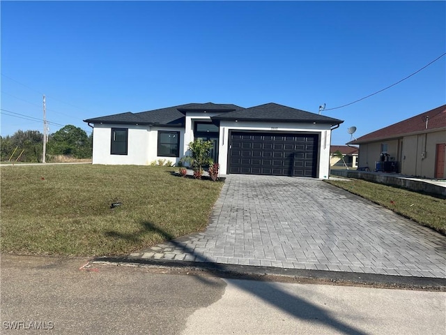 view of front of home with a front lawn and a garage