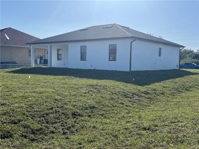 rear view of house with a lawn