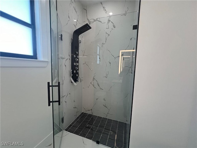 bathroom with a shower with door