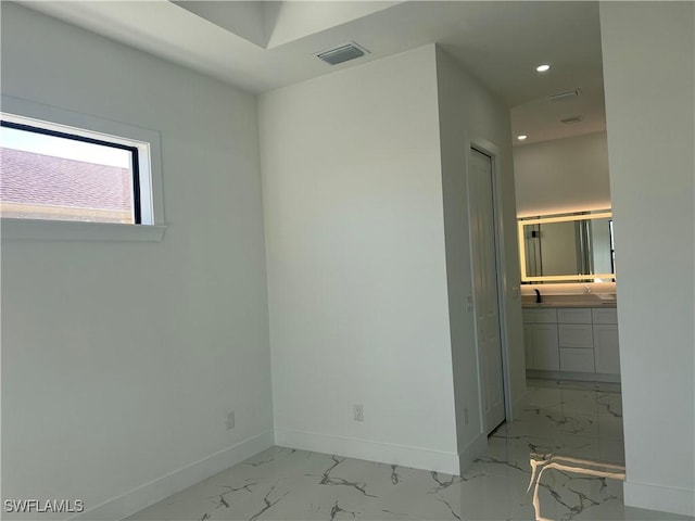 unfurnished bedroom with visible vents, baseboards, marble finish floor, a sink, and recessed lighting