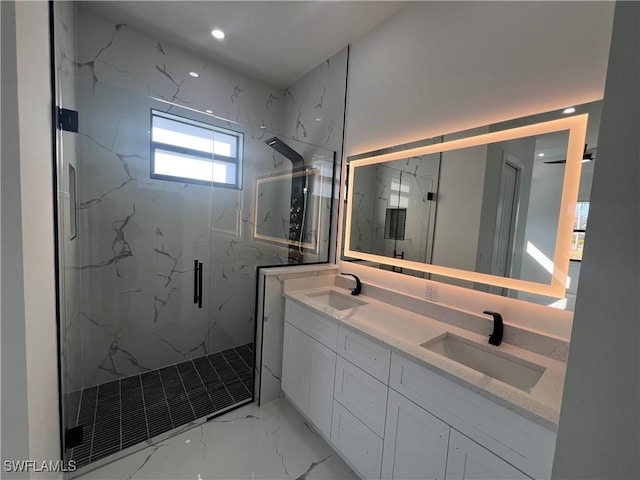 bathroom with marble finish floor, double vanity, a sink, and a marble finish shower