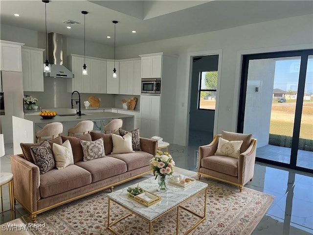 living room featuring marble finish floor, visible vents, and recessed lighting