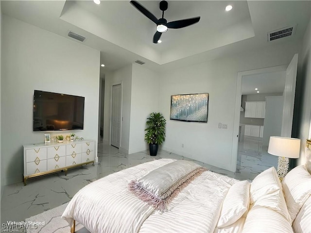 bedroom with marble finish floor, visible vents, and a raised ceiling