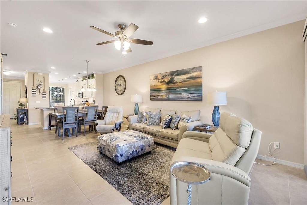 living room featuring ceiling fan, crown molding, and light tile patterned floors