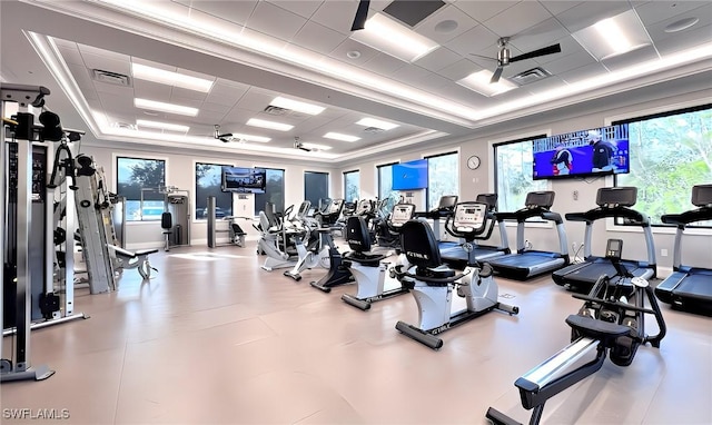 workout area with a paneled ceiling, ceiling fan, and crown molding