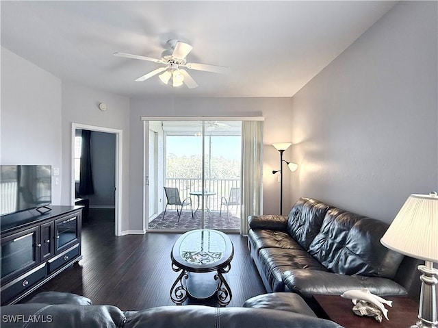 living room featuring ceiling fan and dark hardwood / wood-style flooring