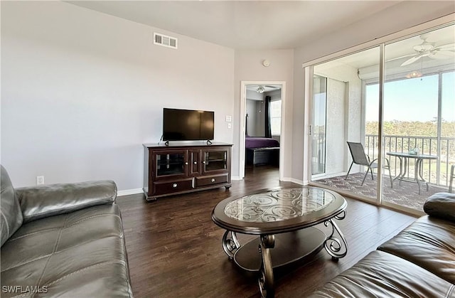 living room with ceiling fan and dark hardwood / wood-style floors