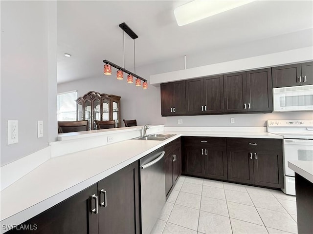 kitchen with sink, kitchen peninsula, white appliances, dark brown cabinets, and light tile patterned flooring