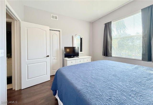 bedroom with dark hardwood / wood-style flooring