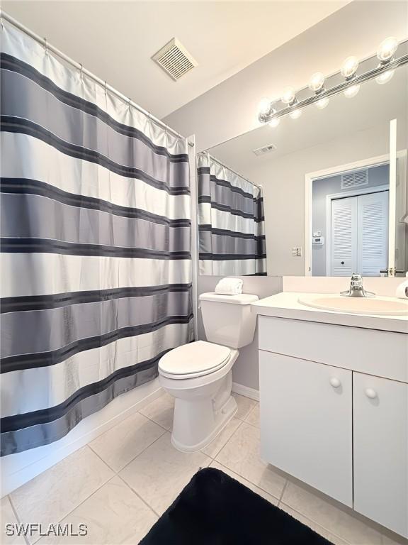 bathroom with tile patterned floors, vanity, and toilet