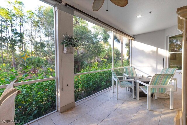 unfurnished sunroom featuring a ceiling fan