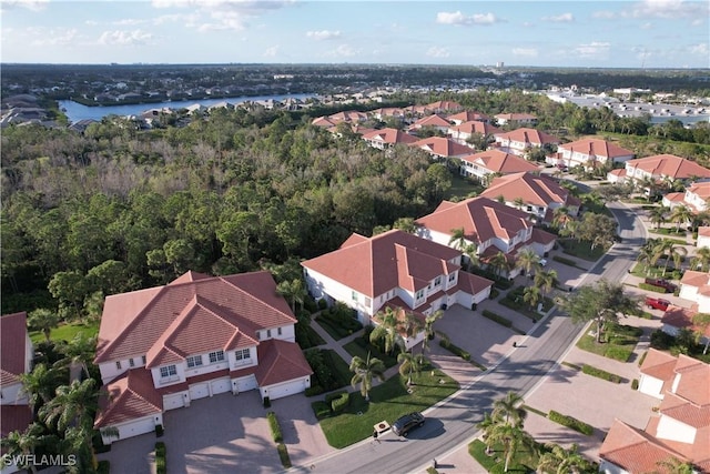 drone / aerial view featuring a water view and a residential view