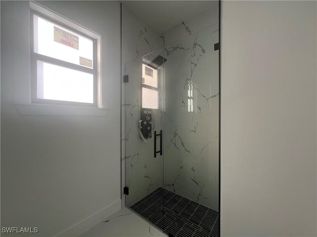 bathroom featuring a shower with door