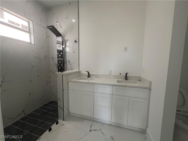 bathroom with vanity and a tile shower