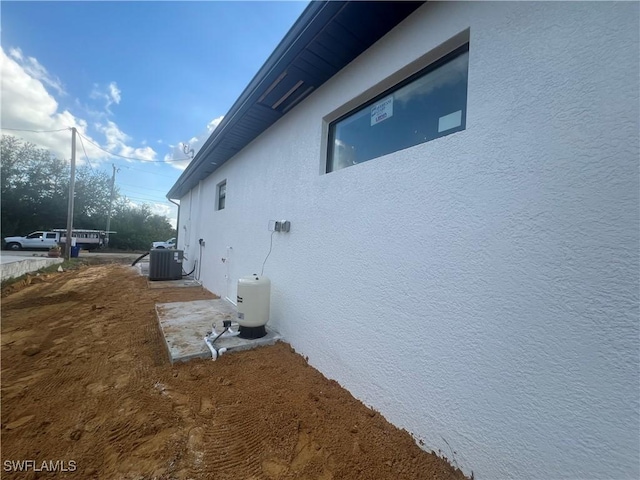 view of side of home with central air condition unit