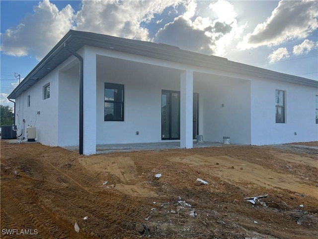 rear view of property featuring cooling unit