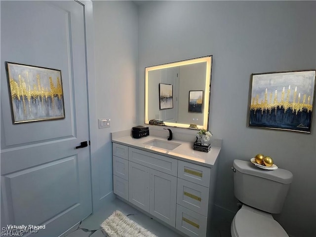 half bath featuring toilet and vanity