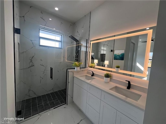 bathroom featuring marble finish floor, double vanity, a sink, and a marble finish shower