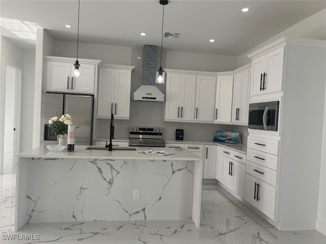 kitchen with stainless steel appliances, pendant lighting, white cabinets, and wall chimney exhaust hood