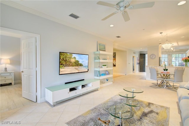 tiled living room featuring ceiling fan with notable chandelier and ornamental molding