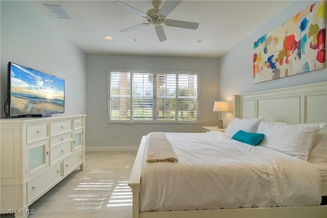 bedroom with light hardwood / wood-style flooring and ceiling fan