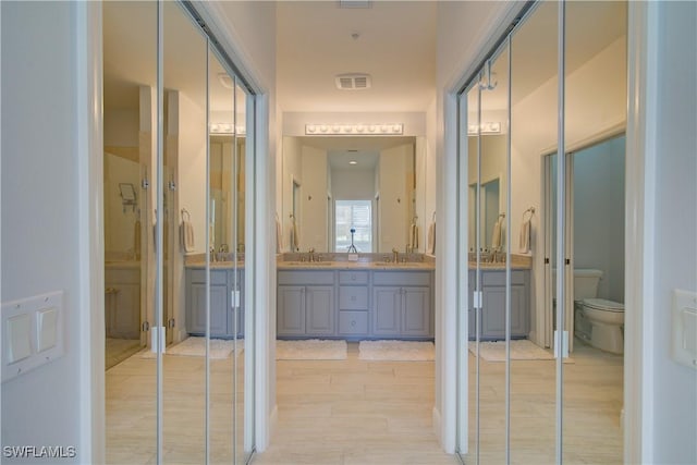 interior space with visible vents, a sink, and light wood finished floors