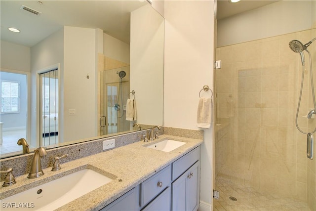 bathroom featuring walk in shower and vanity