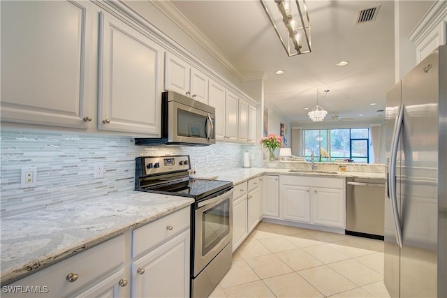 kitchen with crown molding, backsplash, appliances with stainless steel finishes, white cabinets, and a sink