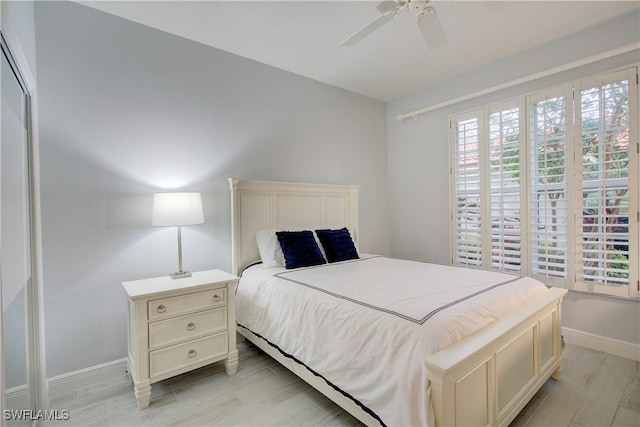 bedroom with ceiling fan and light hardwood / wood-style floors