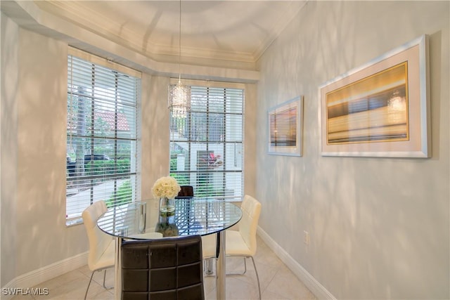 dining space featuring ornamental molding and light tile patterned floors