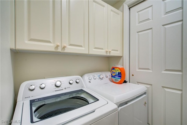 laundry room featuring cabinet space and washer and clothes dryer