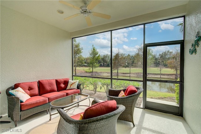 sunroom with a water view and ceiling fan