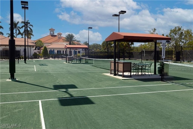 view of tennis court featuring fence