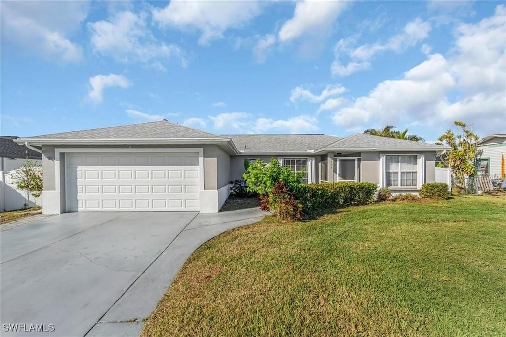 ranch-style home featuring a garage and a front lawn