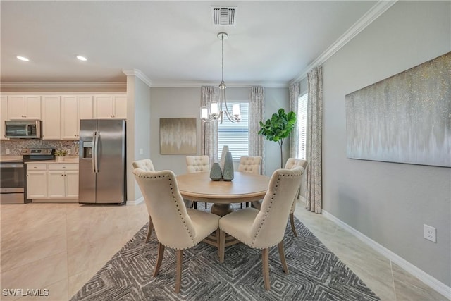 dining area featuring light tile patterned flooring, ornamental molding, and an inviting chandelier