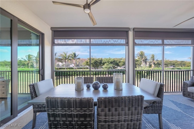 sunroom / solarium featuring ceiling fan