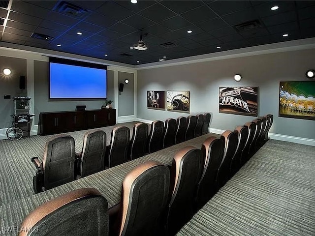 home theater room featuring a drop ceiling and carpet floors