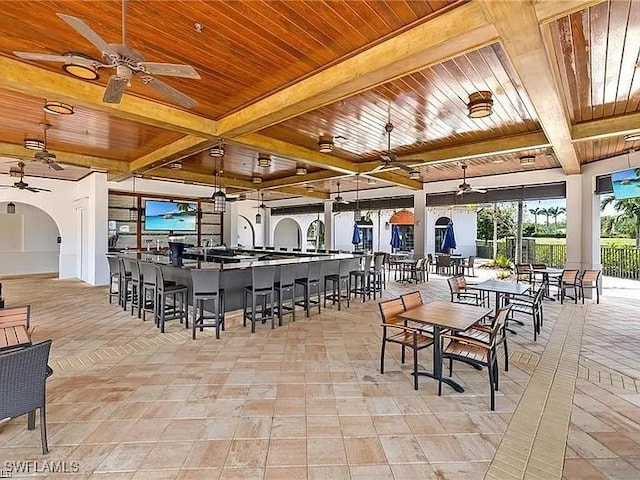 dining area with beamed ceiling and wood ceiling