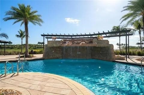 view of pool with a patio area and pool water feature