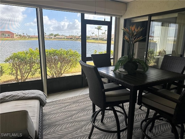 sunroom / solarium featuring a water view