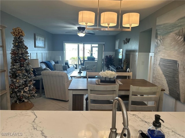 tiled dining room with ceiling fan