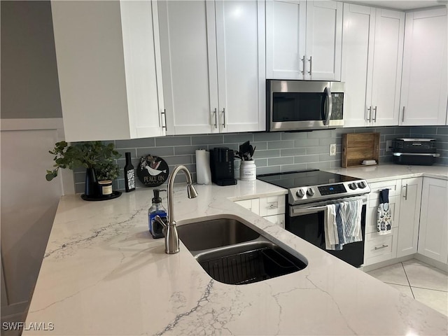 kitchen featuring white cabinets, appliances with stainless steel finishes, and sink