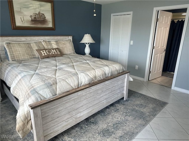 bedroom with tile patterned floors and a closet